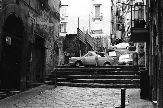 grayscale photography of gray car above staris in Metropolitan City of Naples Italy