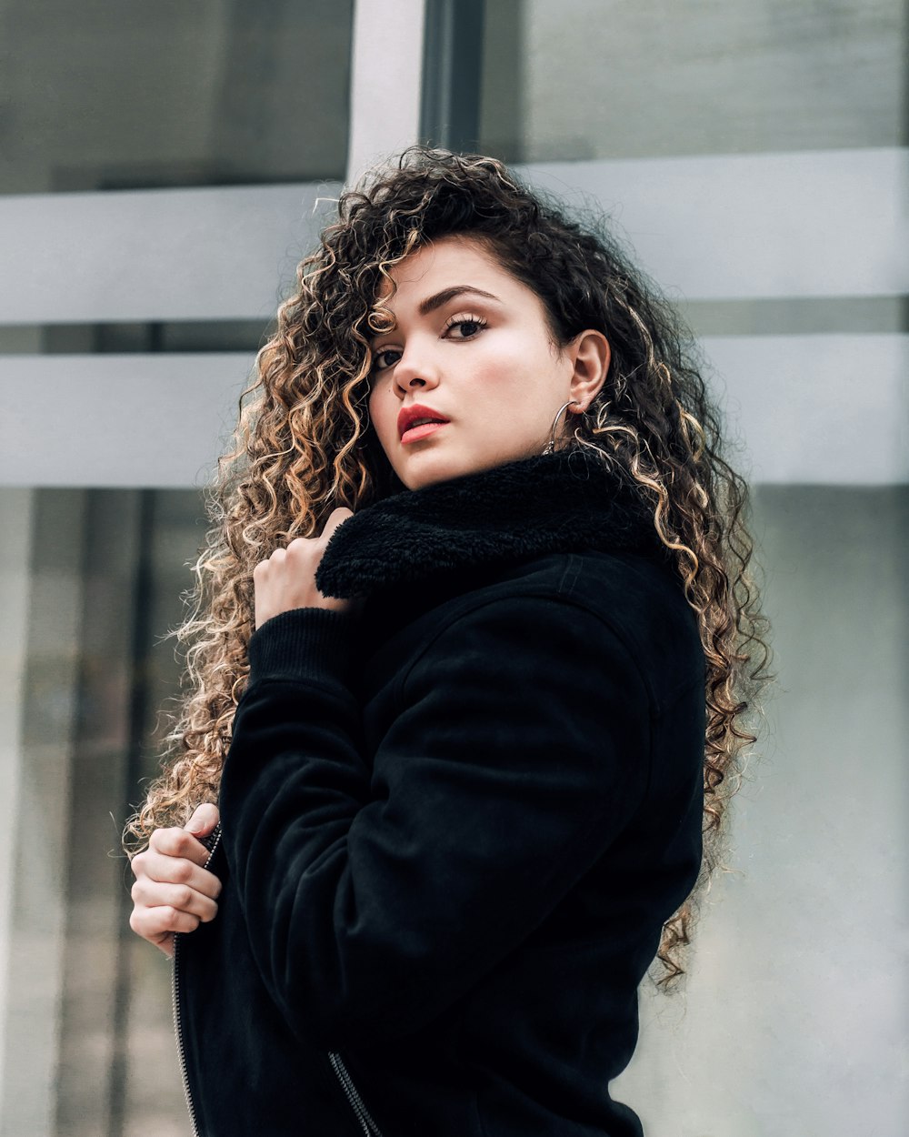 selective focus photography of woman holding coat