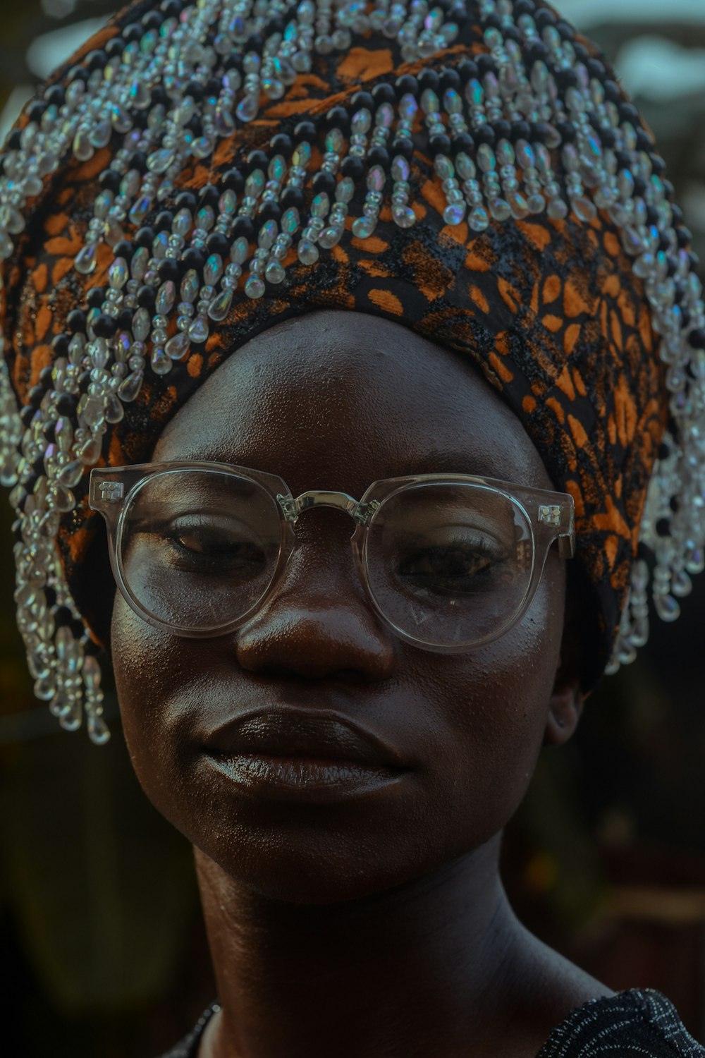 woman wearing orange and black head dress