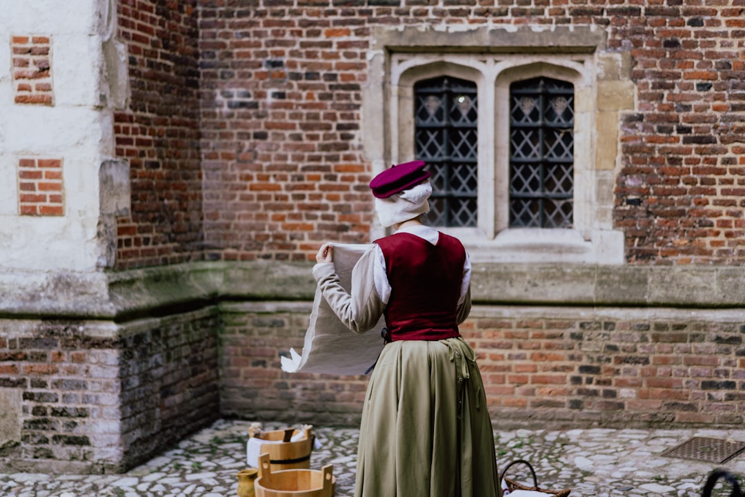 woman doing laundry outside with brown buckets