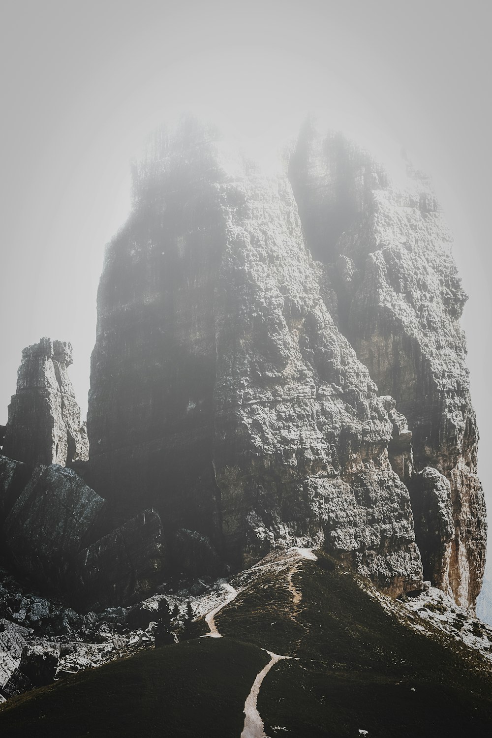 grey rock formation under cloudy skies