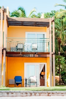 orange and white 2-storey building beside palm tree