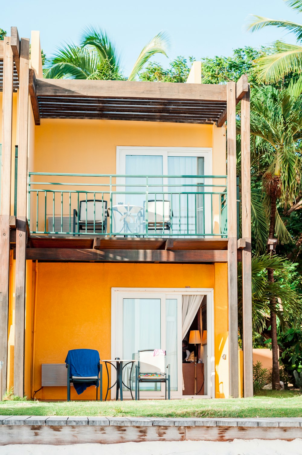 orange and white 2-storey building beside palm tree