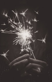 Close-up of hands carefully handling certified fireworks packaging.
