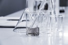 three clear beakers placed on tabletop