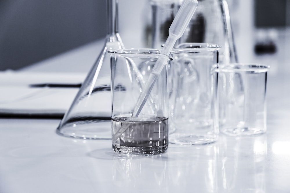 three clear beakers placed on tabletop