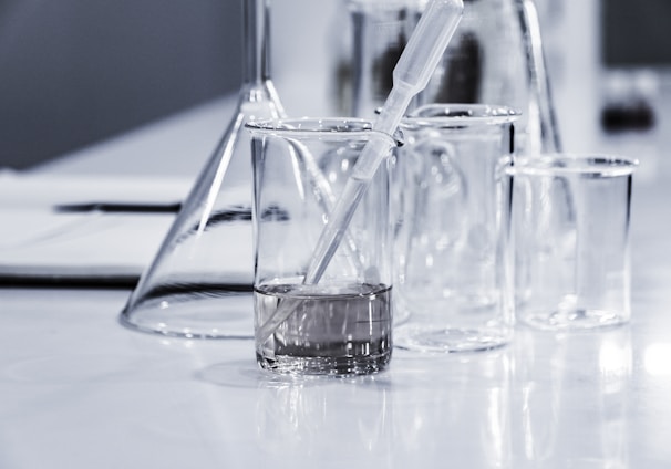 three clear beakers placed on tabletop