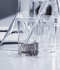 three clear beakers placed on tabletop