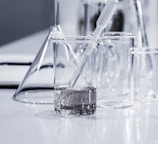 three clear beakers placed on tabletop