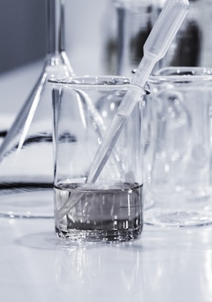 three clear beakers placed on tabletop