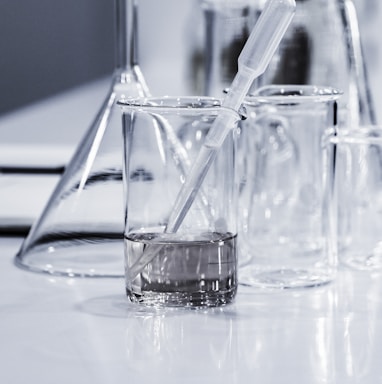 three clear beakers placed on tabletop