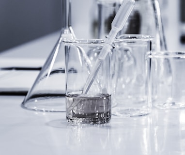 three clear beakers placed on tabletop