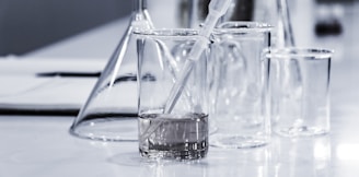 three clear beakers placed on tabletop