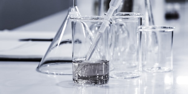 three clear beakers placed on tabletop