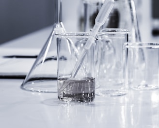 three clear beakers placed on tabletop