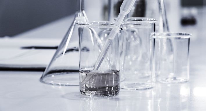 three clear beakers placed on tabletop