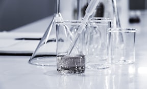 three clear beakers placed on tabletop