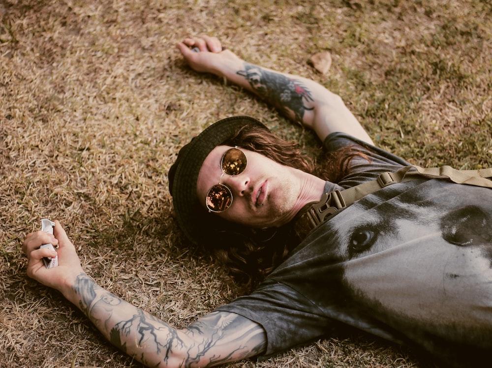 man lying on dried grass