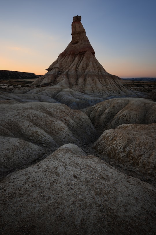 brown mountain on body of water in Bardenas Reales Spain