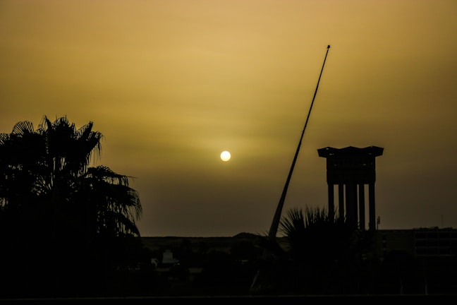 A sunrise casting golden light over ancient ruins, symbolizing hope and new beginnings.