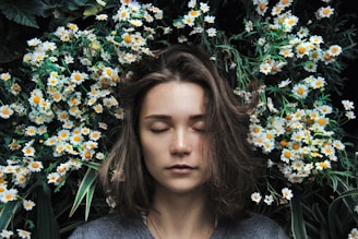 woman closing her eyes on white flower