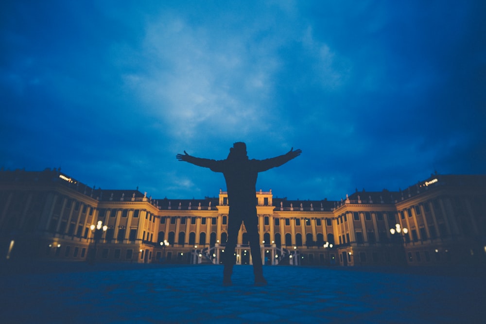 person standing in front of the brown building