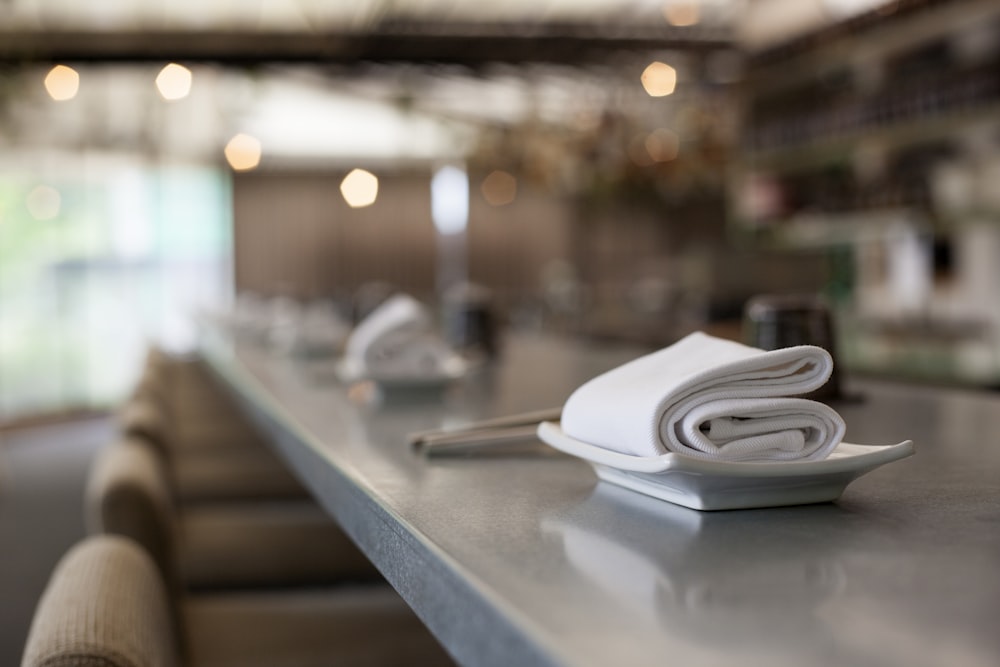 selective focus photography of white textile on platter