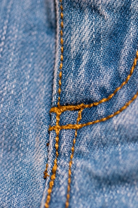 Close-up of a pair of soulsoo denim jeans with unique stitching details.