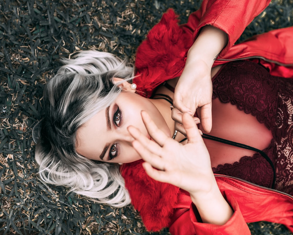 woman lying on grass field