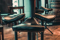 Industrial style barstool featuring a distressed metal frame and wooden seat, ideal for loft spaces.