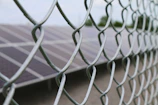 Solar fencing panels securing a commercial property at dusk.