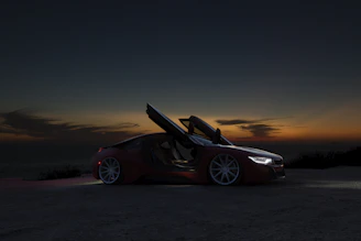 A sleek luxury car parked by a scenic coastal road at sunset with a friendly driver opening the door.