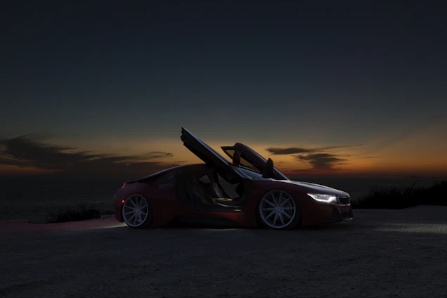 A sleek luxury car parked by a scenic coastal road at sunset with a friendly driver opening the door.