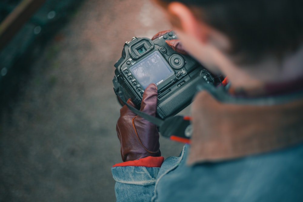 person holding DSLR camera