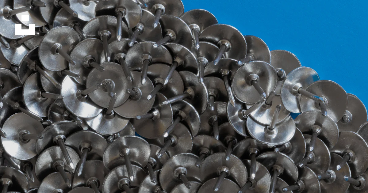 Button Shell Pile A pile of metal buttons sitting on top of a table photo – Free Blue ...