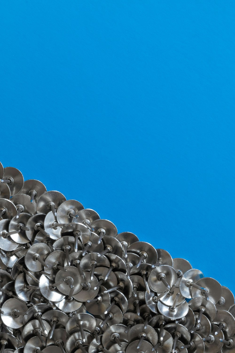 a pile of metal buttons sitting on top of a table