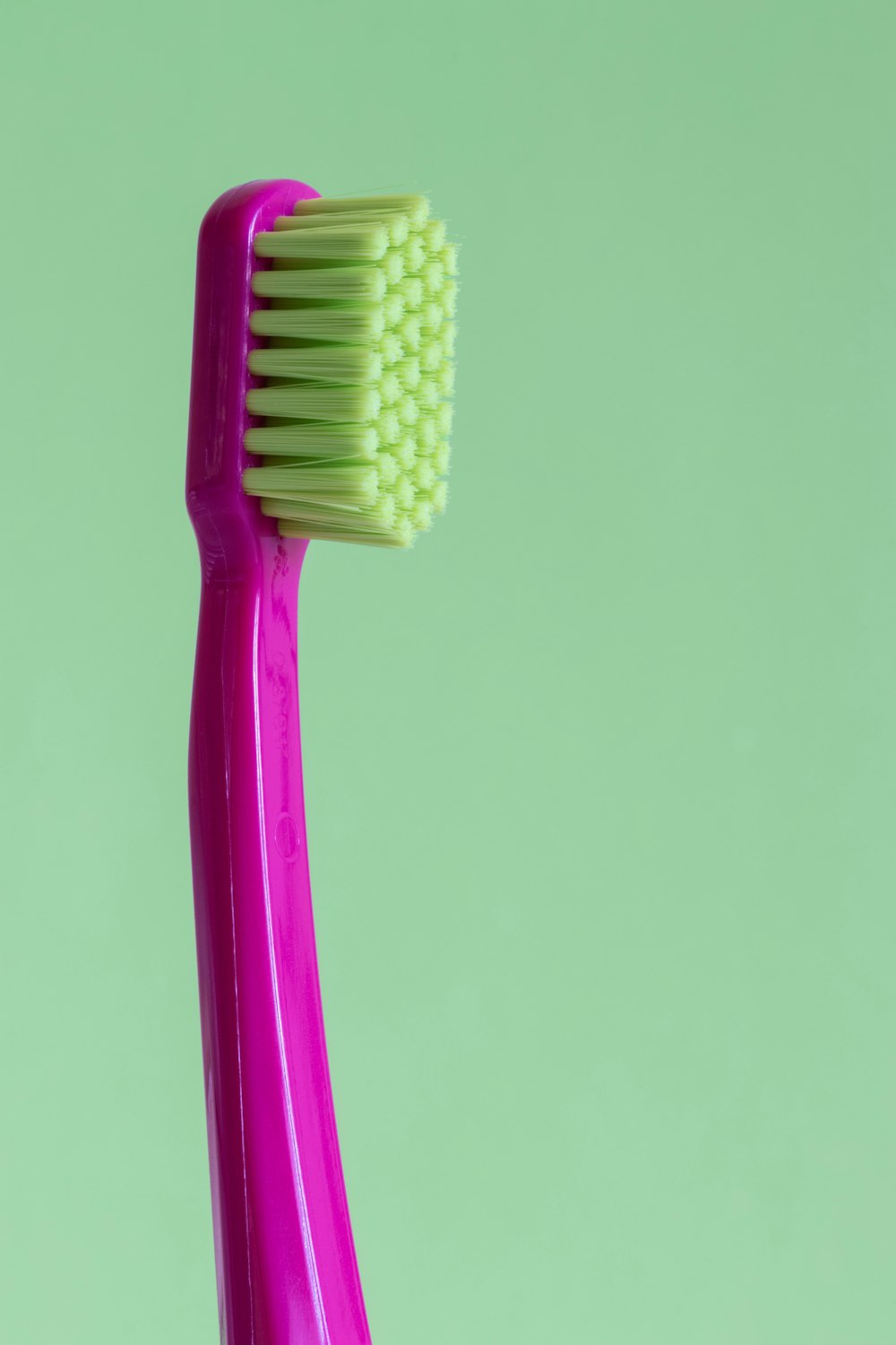 purple and green toothbrush