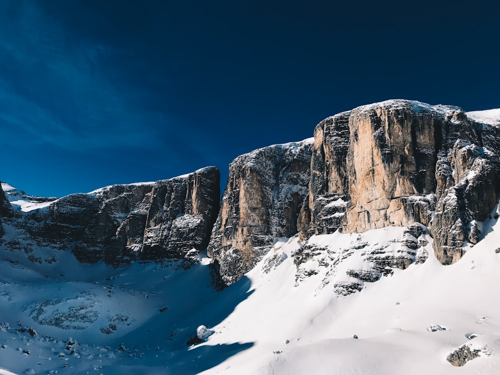 brown cliffs coated with snow