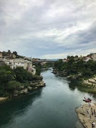 A serene blue river flowing gently through a vibrant community gathering.