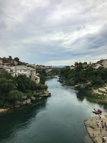 A serene blue river flowing gently through a vibrant community gathering.