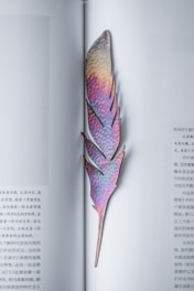 purple and brown leaf bookmark on page