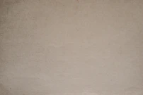 a brown paper background with a black and white cat sitting on top of it