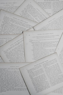 Various pages containing text are scattered, displaying sections with titles such as 'Natural and Common Objects,' 'General Topics,' and 'Technical Points.' The pages appear to be from a book or document discussing educational or instructional topics.