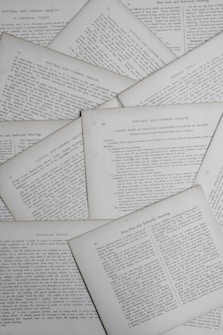 Various pages containing text are scattered, displaying sections with titles such as 'Natural and Common Objects,' 'General Topics,' and 'Technical Points.' The pages appear to be from a book or document discussing educational or instructional topics.