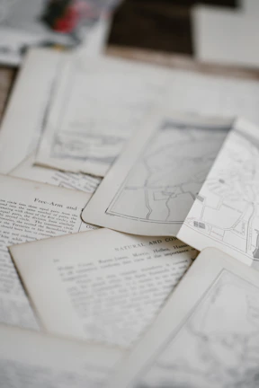 Close-up of historical documents and letters spread out on a wooden table.