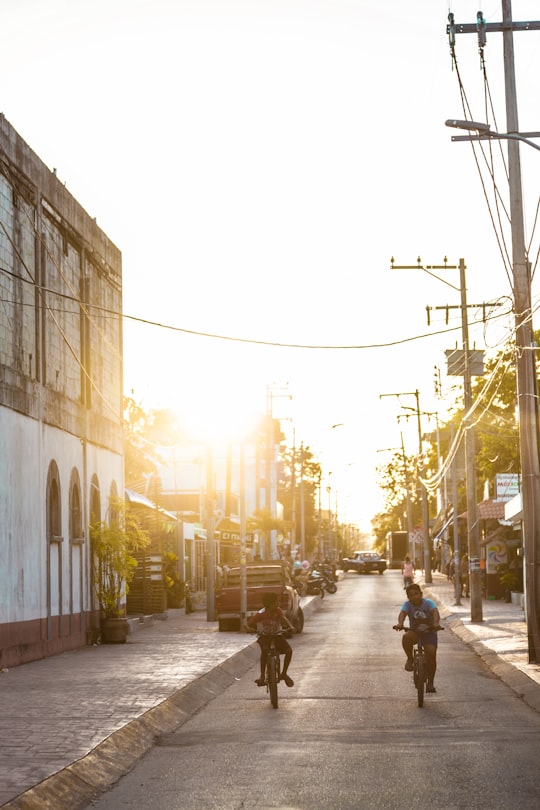 two boys riding on bike in Bacalar Mexico