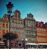 people walking in front of multicolored buildings
