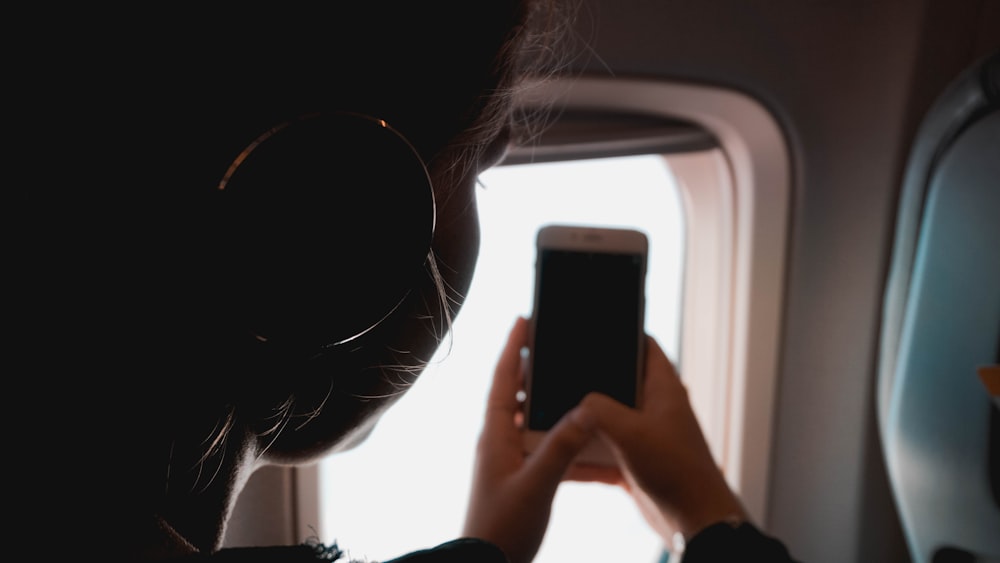 person holding smartphone on plate