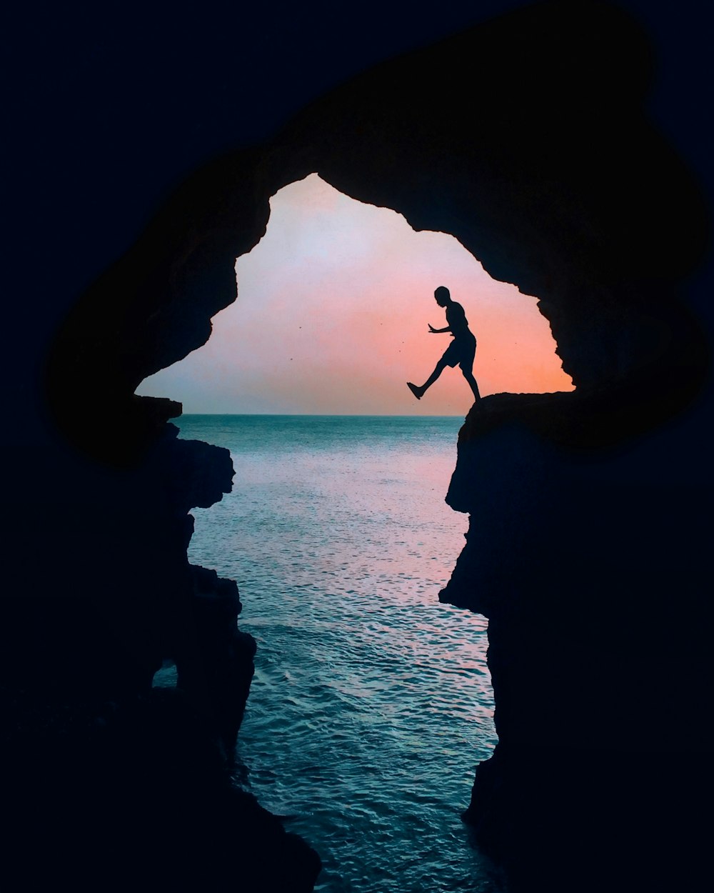 silhouette photography of a man on cliff