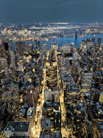An aerial view of Kinshasa’s bustling urban landscape at dusk with warm city lights